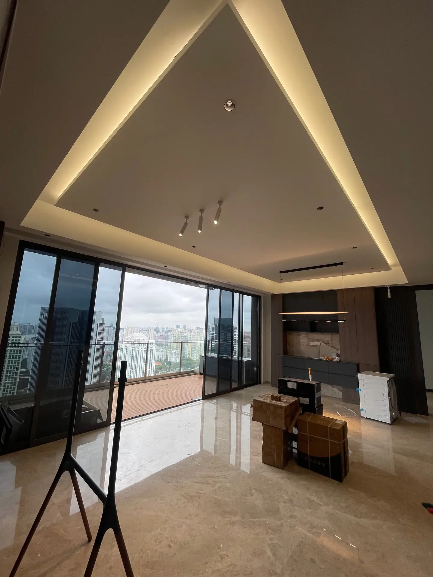 Interior design at **The Avenir**, Singapore: a rectangular island false ceiling with cove lighting serves as a striking focal point and adds a sense of spaciousness to the living room.
